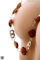 A close up of a necklace on a mannequin head.