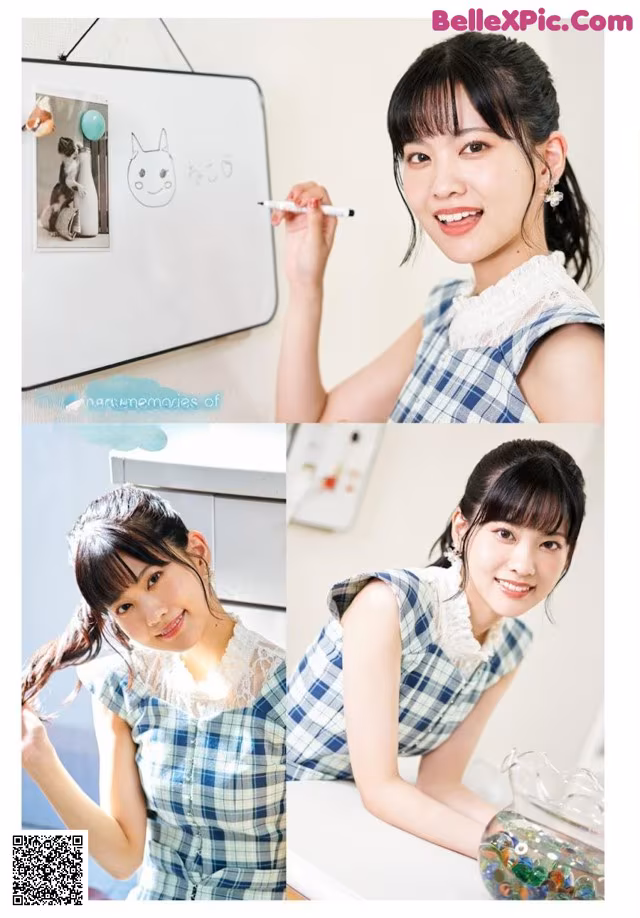 A woman in a blue and white plaid dress writing on a whiteboard.