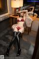 A woman in a red lingerie sitting on a chair.