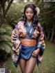 A woman in a blue and orange kimono posing for a picture.